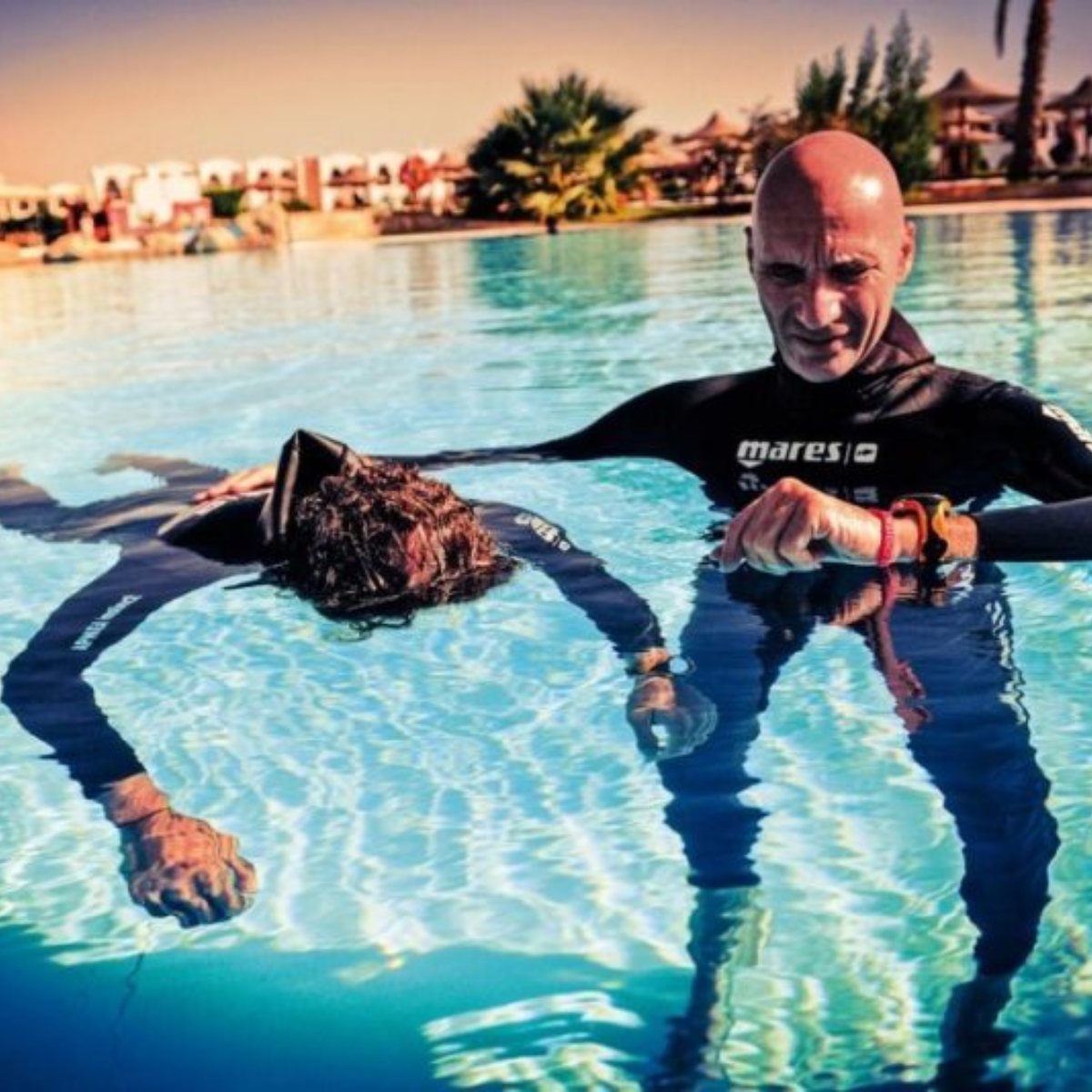 A freediver floating calmly face-down in static apnea in calm Boracay water