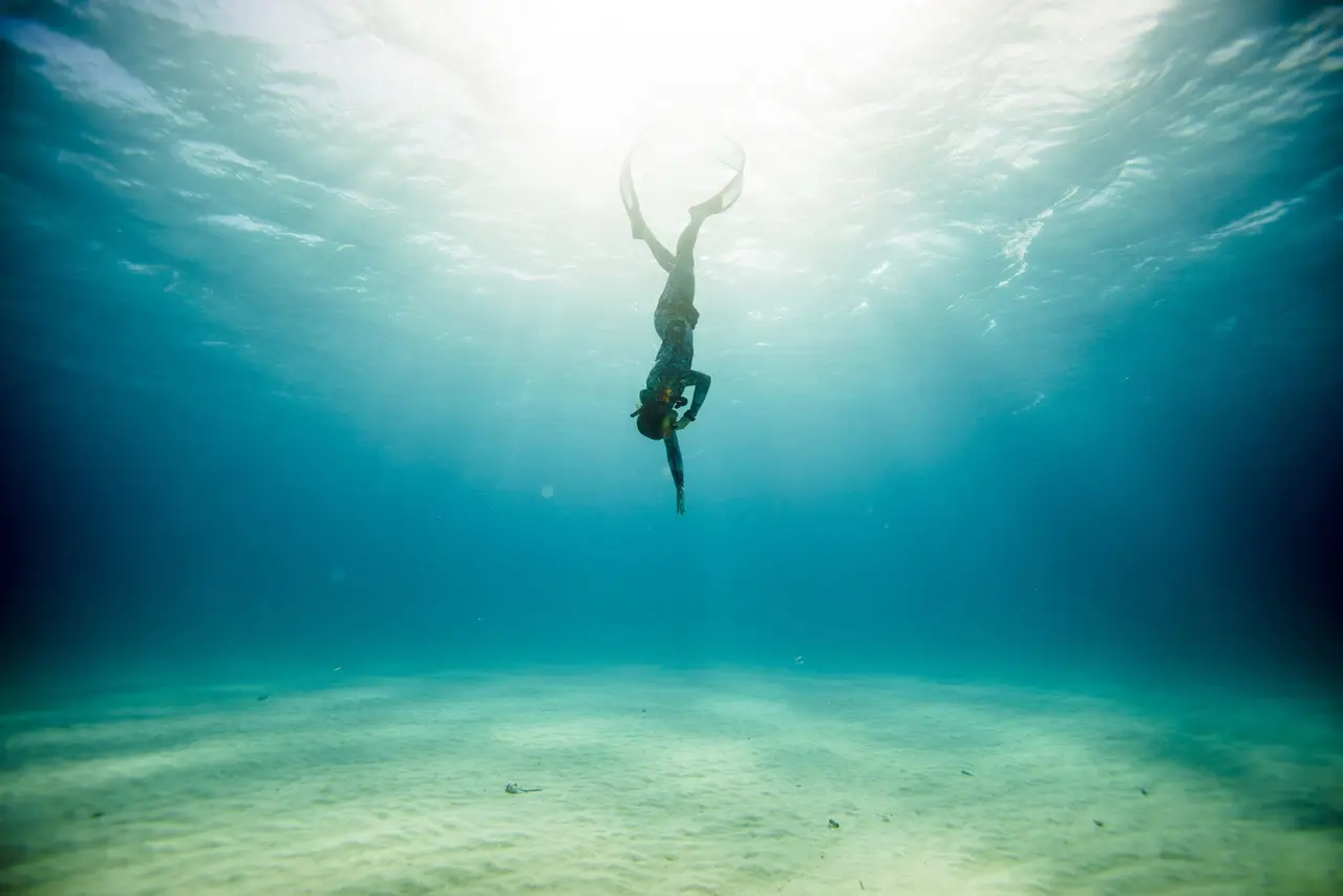 A freediver floating calmly beneath the surface in Boracay
