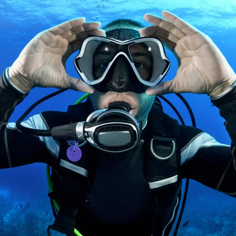 A diver reviewing skills in calm water with an instructor