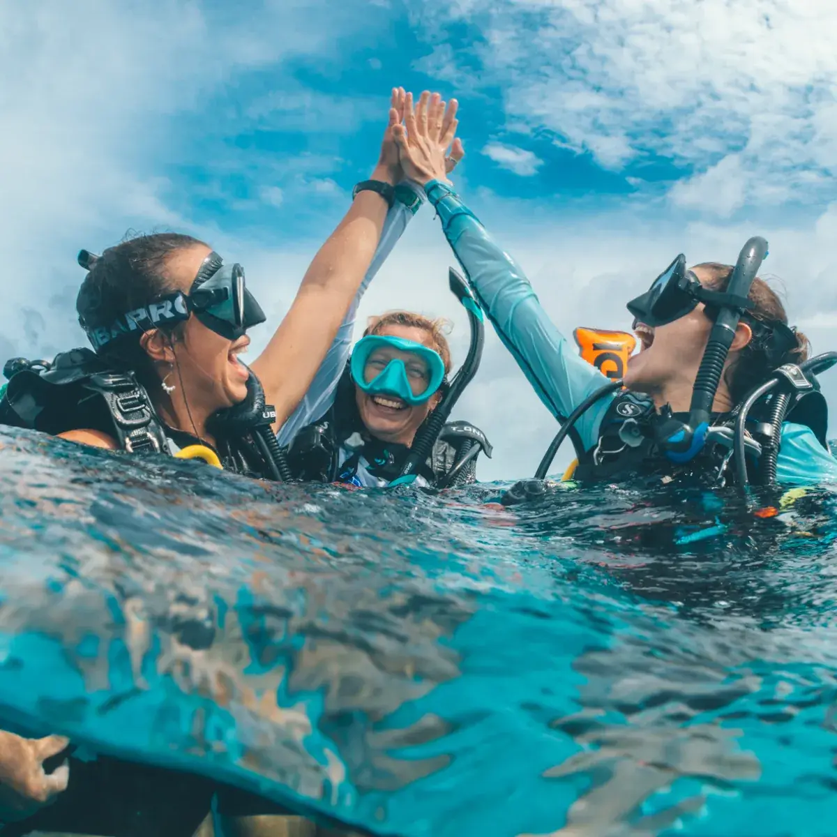 Two scuba divers descending into Boracay's deep blue water