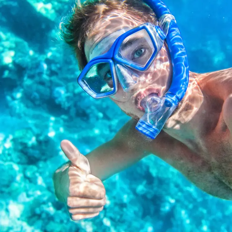 A snorkeler gliding over a colourful coral reef in Boracay